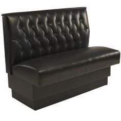 a black leather couch sitting on top of a wooden table