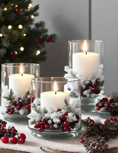 three candles are sitting on a table with christmas decorations