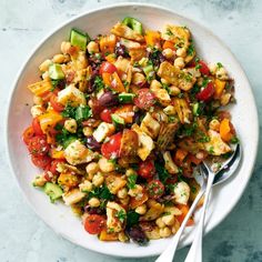 a white bowl filled with vegetables and chickpeas