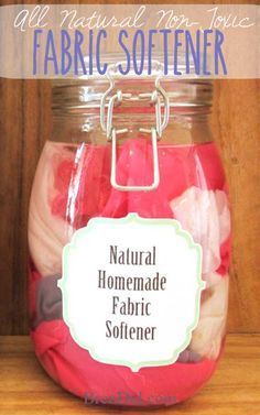 a jar filled with fabric sitting on top of a wooden table next to a sign