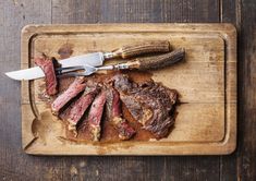 the steak has been sliced and is ready to be served on the cutting board with a knife