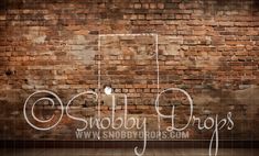 an old brick wall with the words snobby drops written on it in white spray paint