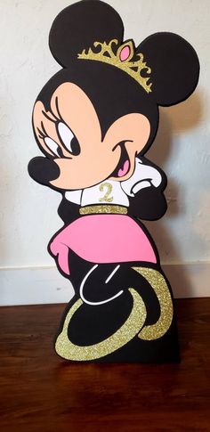 a cardboard cutout of minnie mouse wearing a tiara