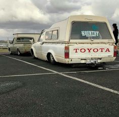 an old toyota van is parked in a parking lot