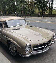 an old car is parked on the side of the road