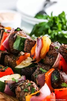 skewers of meat and vegetables on a cutting board