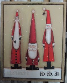 three santas are standing next to each other in front of a wooden sign that says happy holidays