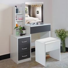 a white desk with drawers and a mirror