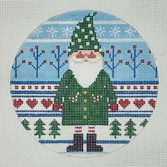 a cross - stitch christmas card with a santa clause in the center and trees on it