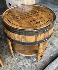 a wooden barrel table sitting on top of a cement floor