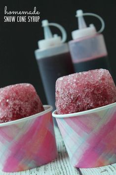 two cups filled with pink and white sugar