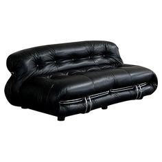 a black leather futon sofa sitting on top of a white floor