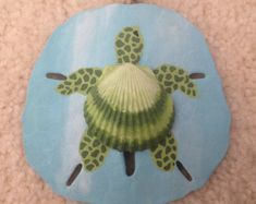 a sea turtle shell with green and blue designs on it