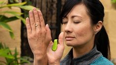 a woman is holding her hands together to pray