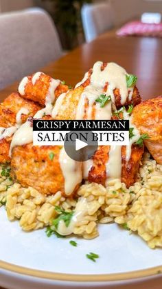 crispy parmesan salmon bites served over pasta on a white plate with creamy sauce