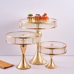 three tiered cake stand with cakes on top