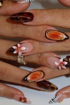 Discover gorgeous and luxurious long brown and gold nail designs! From simple french tips to luxe intricate gold and brown designs, these ideas will have your jaw on the floor. Nails Artist Aesthetic, Kalogeras Nails, Orange Trendy Nails, Tropical Nails Design, Y2k Almond Nails, Nail Artist Aesthetic, Auburn Nails, Almond Nail Design Ideas, Eclectic Nails