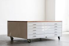 a white dresser sitting on top of a hard wood floor