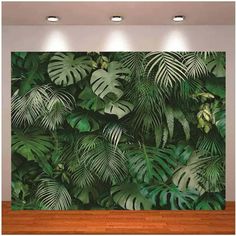 a large wall mural with green leaves on it in an office space, featuring two recessed lights