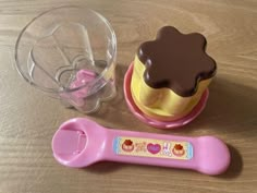 a toy ice cream scooper and cupcake on a table