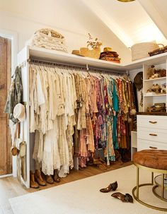 an organized closet with clothes and shoes