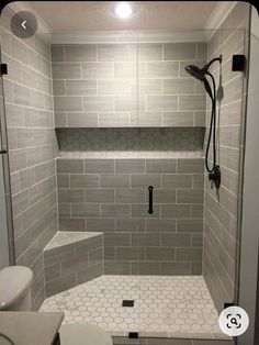 a walk in shower sitting next to a toilet