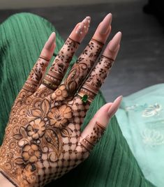 a woman's hand with henna on it