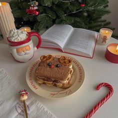 a sandwich on a plate with pretzels and candy canes next to it