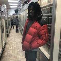 a man with dreadlocks standing in a store