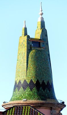 a very tall building with a clock on it's face and two spires