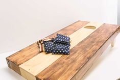 a wooden board with ties on it and an american flag bow tie laying on top