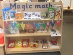 a book shelf filled with lots of books on top of wooden shelves next to other children's toys