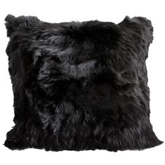 a black furry pillow on a white background