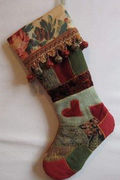 a christmas stocking hanging on a wall with hearts and flowers in the bottom half