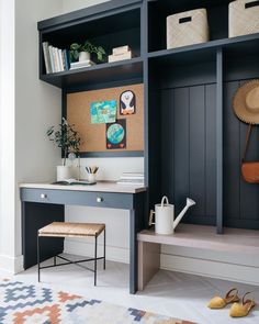 a room with a desk, chair and bookshelf filled with various items on it