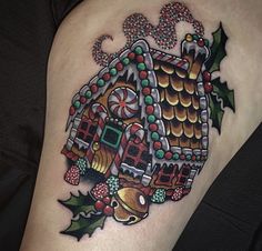 a christmas themed house tattoo on the thigh