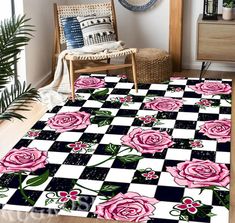 pink roses on black and white checkerboard rug in the corner of a room