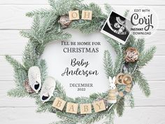 a christmas wreath with baby's name and pictures on it, surrounded by pine branches