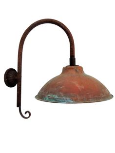 an old - fashioned wall light with a metal arm and dome shade on the side