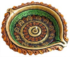 an intricately decorated dish with gold and green accents