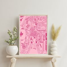 a pink poster on a shelf next to a vase with flowers and a potted plant