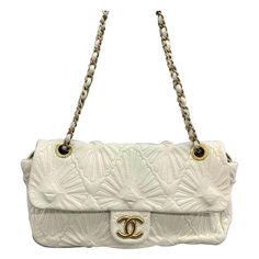 Chanel Paris-Venice Ca D‚ÄôOro Flap Bag Seashell 3D Embroidered Flap Bag 2009 Large Off White This item is a genuine CHANEL Lambskin Quilted Ca D'Oro Flap in Off White. The elegant handbag bag is exquisitely crafted from soft lambskin leather and showcases intricate embroidery. It boasts shoulder straps made of gold chain links with leather threading, as well as a front flap adorned with a gold-tone Chanel CC turn lock. CONDITION: EXCELLENT Light creases on the bottom. Rubbing around the corners Luxury White Quilted Shoulder Bag, White Quilted Bag For Formal Occasions, White Quilted Evening Bag, Luxury Quilted Cream Shoulder Bag, Luxury Leather Shoulder Bag With Embroidered Logo, Elegant Evening Bags With Embossed Details, Elegant Embossed Evening Bags, Luxury Leather Bags With Embroidered Logo, Designer Formal Bag With Embossed Details