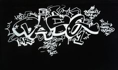 graffiti written on the side of a black wall with white letters and words all over it