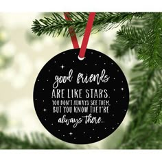 a black ornament hanging from a christmas tree with the words, good friends are like stars you don't always set them but you know they're already there