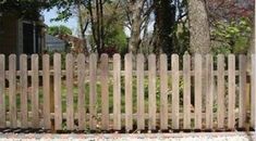 a wooden fence in front of a house