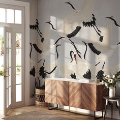 the wallpaper in this room is decorated with cranes