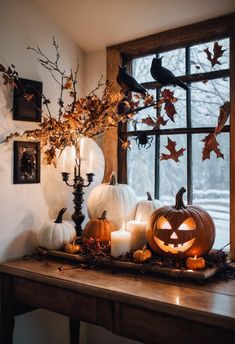 pumpkins and candles on a table in front of a window