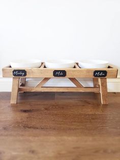 three bowls are sitting on a wooden bench