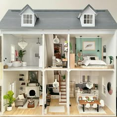 a doll house with all the furniture and accessories in it, including stairs to the second floor