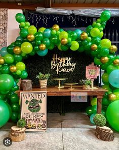 a green and gold birthday party with balloons